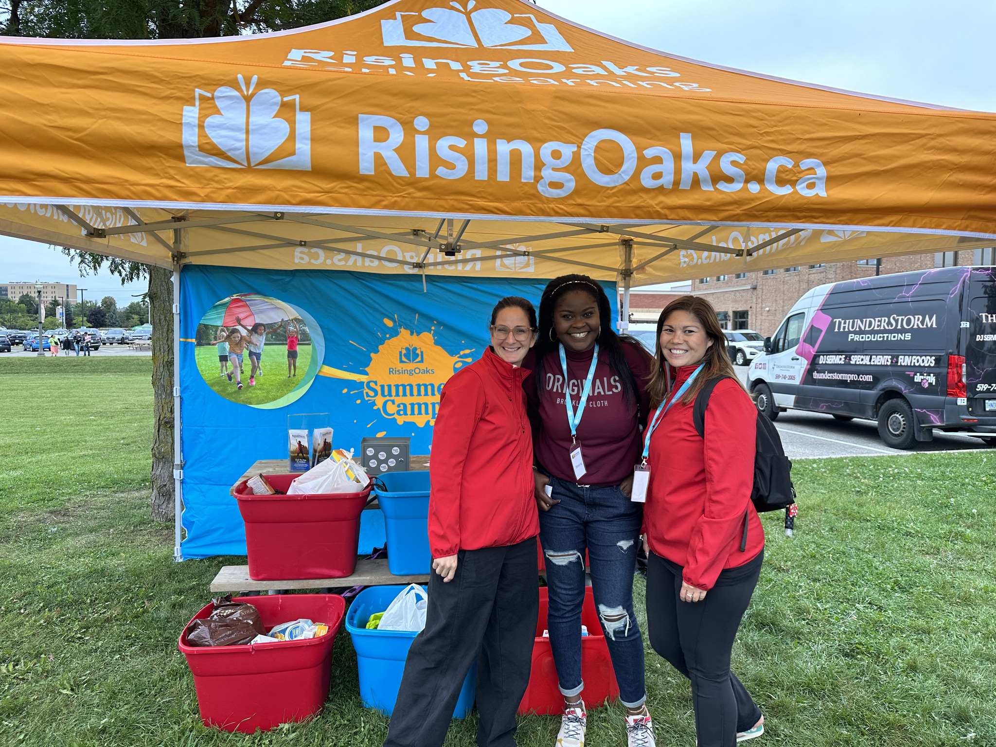 board memebers standing at food donation tent