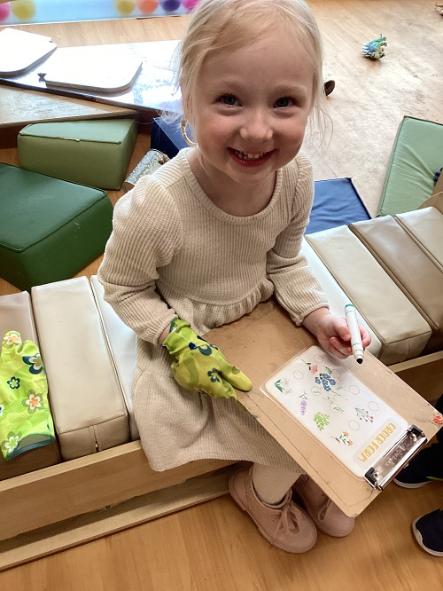 A child working on a garden themed scavenger hunt.