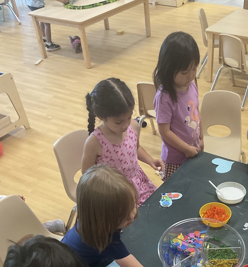 2 girls in pink at the craft table