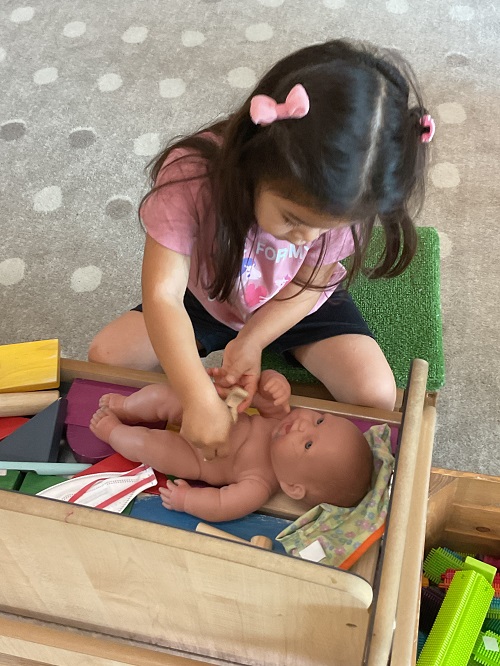 little girl doing a check up in a crib