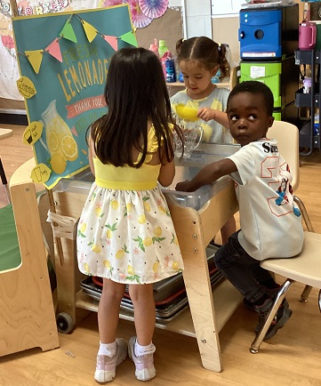 children playing at the pretend lemonade stand