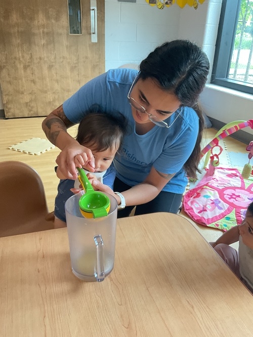 The Infants at RisingOaks | St. Patrick had the opportunity to explore a hands-on experience, participating on the process of squeezing orange into a pitcher and tasting the juice during snack. The infants used their senses and practiced their fine-motor skills.