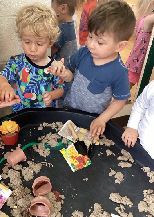 children exploring with gardening materials