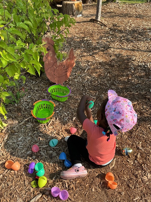 Child finding a toy chicken egg