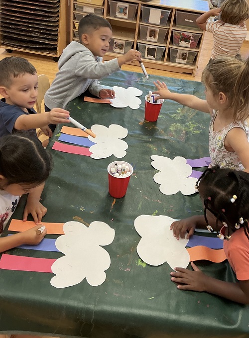 Children colouring at a table together.