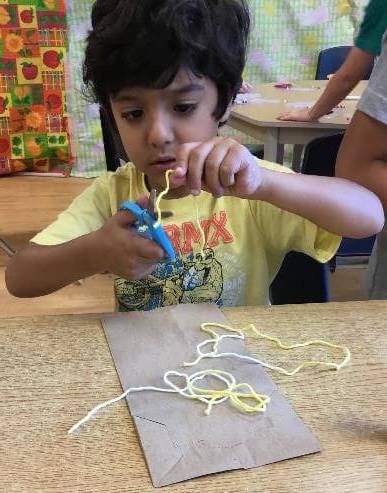 boy cutting string
