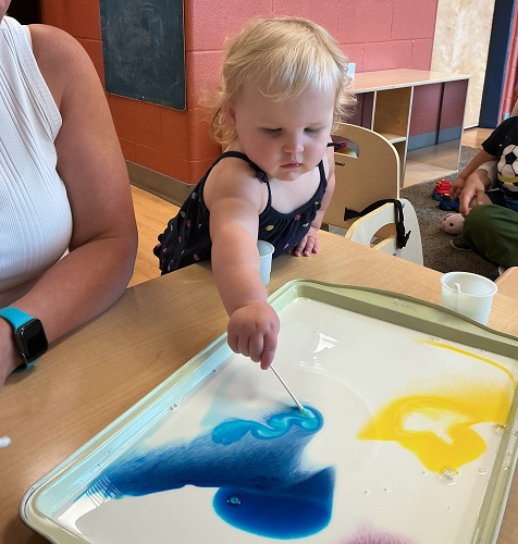 Child exploring with a science experiment