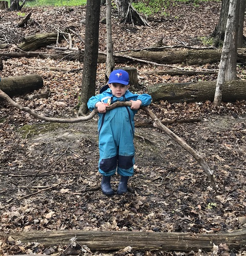 A child holding a large stick