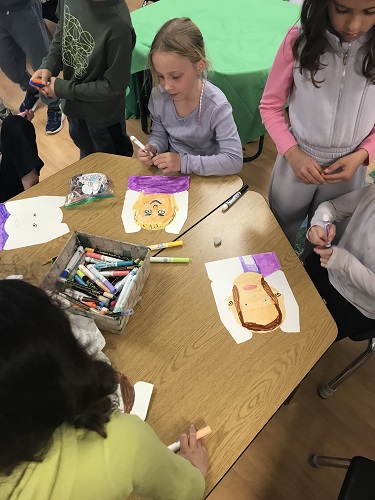 Children working on drawing portraits of their mothers